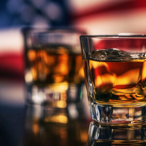 Glass of Rye Whiskey with an American flag in the background