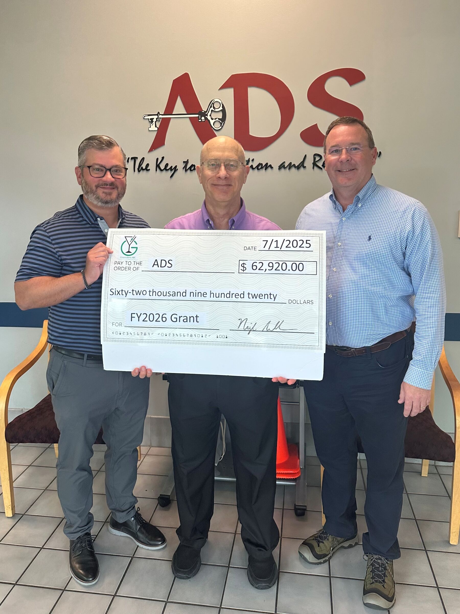 ADS accepting a grant check from Greensboro ABC for $62,920.