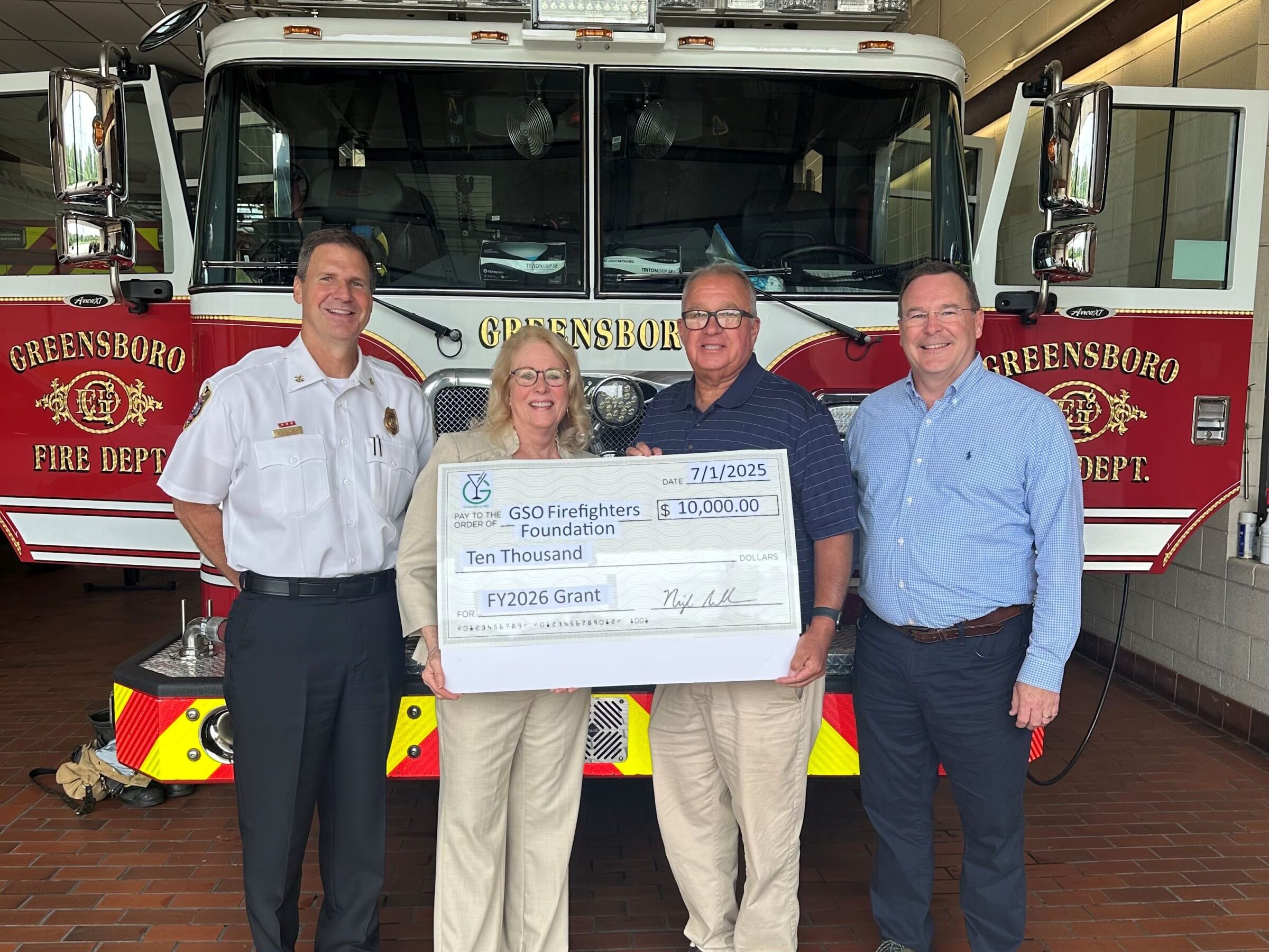 Greensboro Firefighters Foundation accepting a grant check from Greensboro ABC for $10,000.