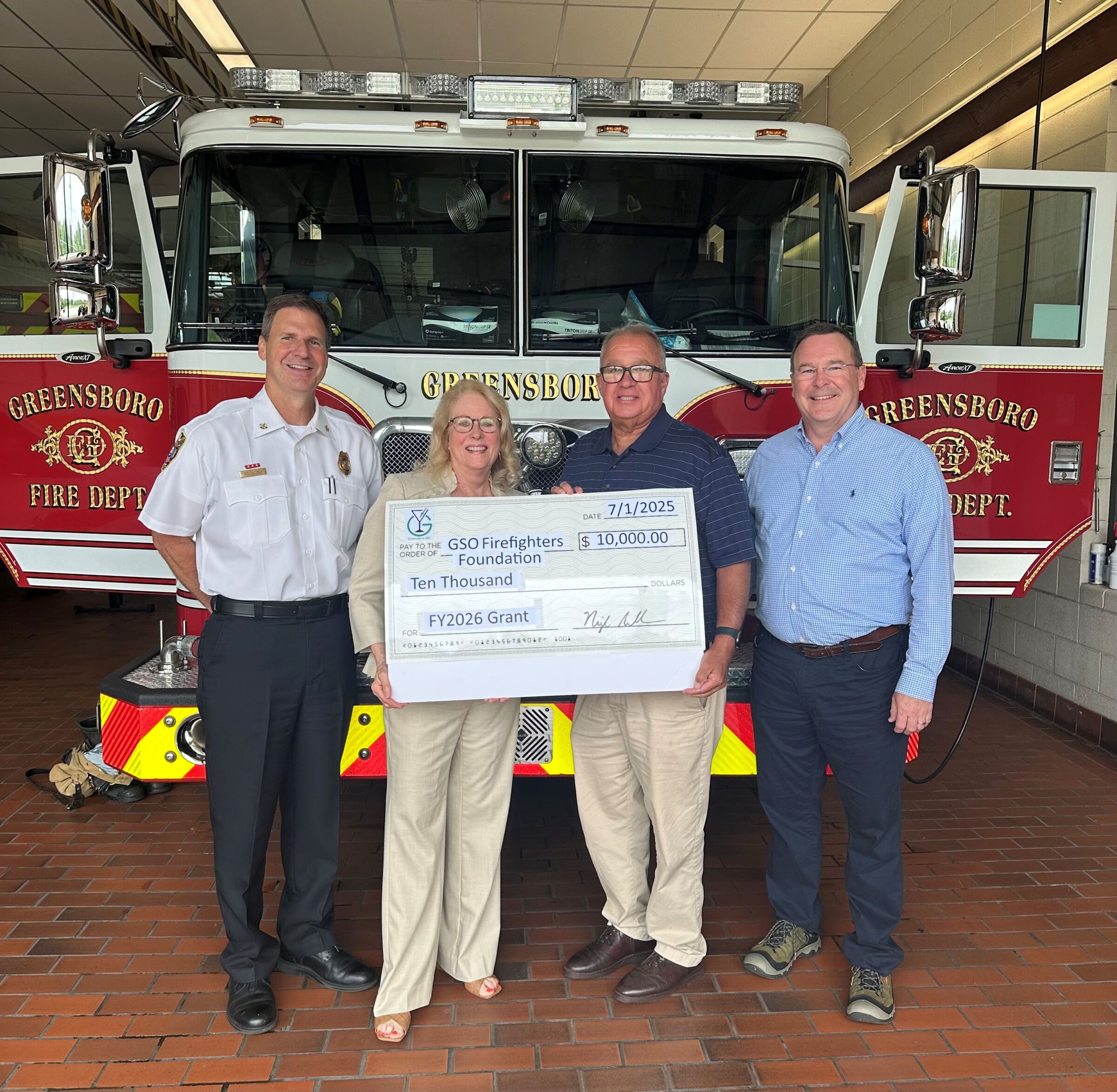 Greensboro Firefighters Foundation accepting a grant check from Greensboro ABC for $10,000.