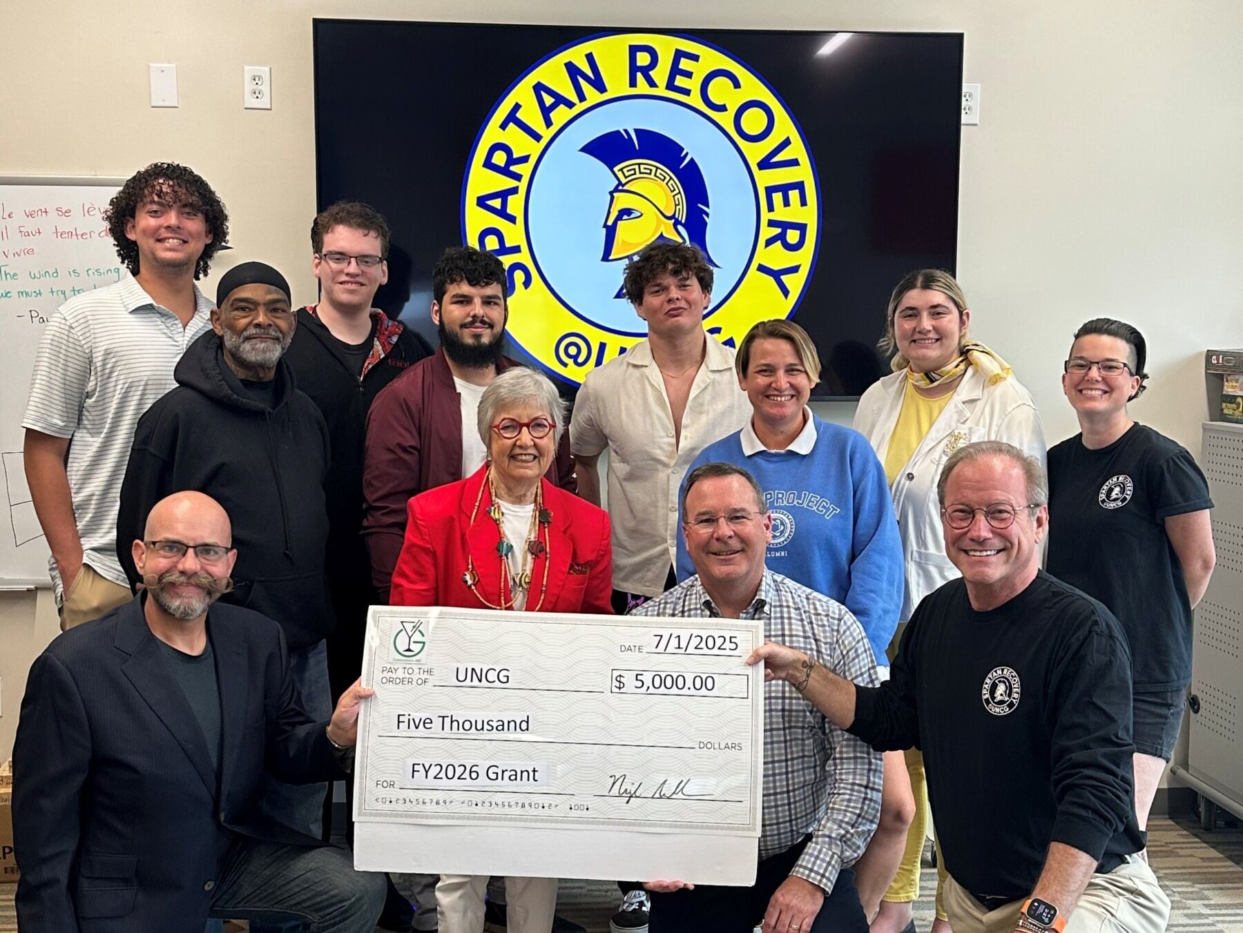 Spartan Recovery at UNCG accepting a grant check from Greensboro ABC for $5,000.
