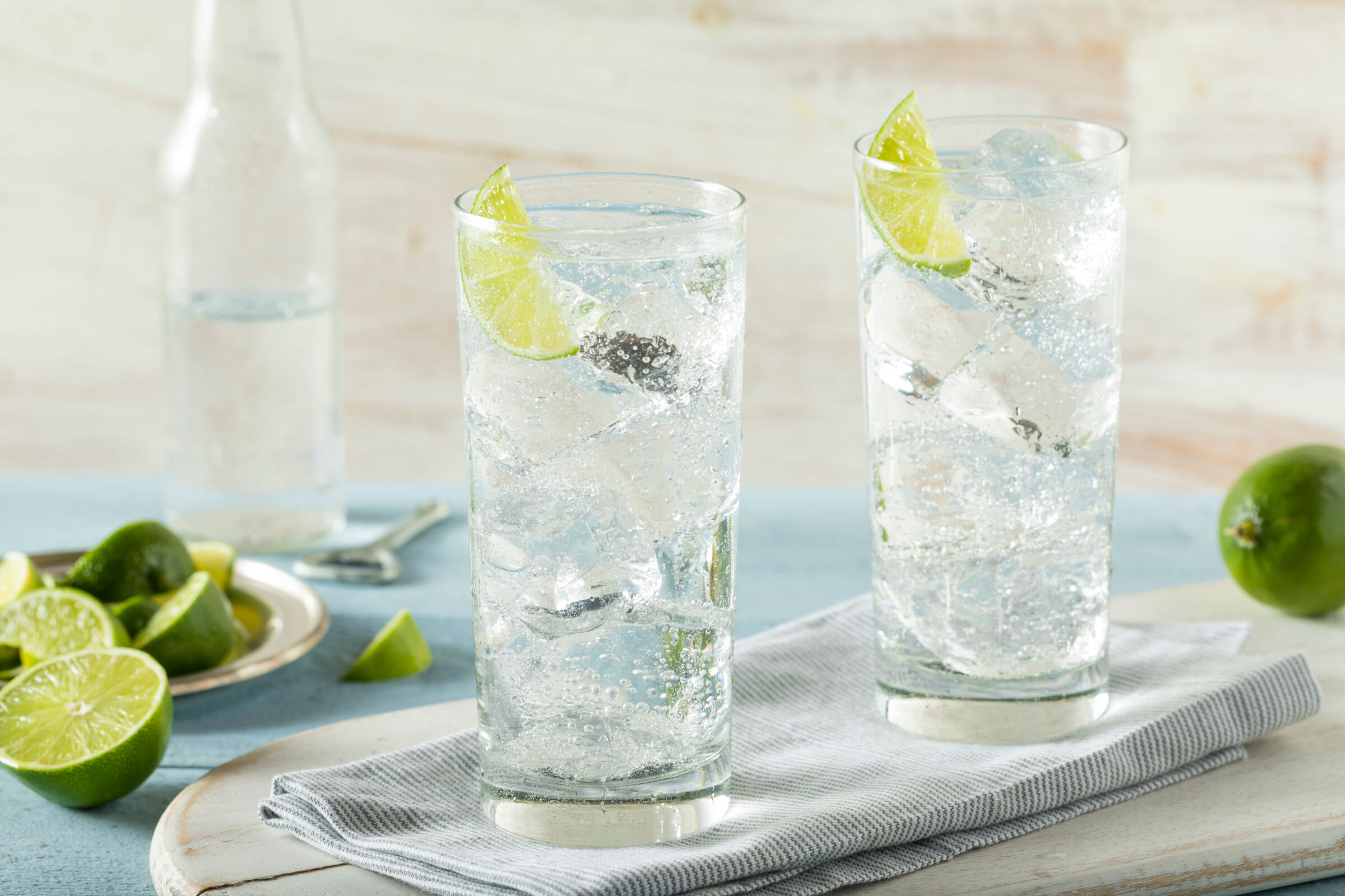 Glass with a vodka drink containing lime and ice
